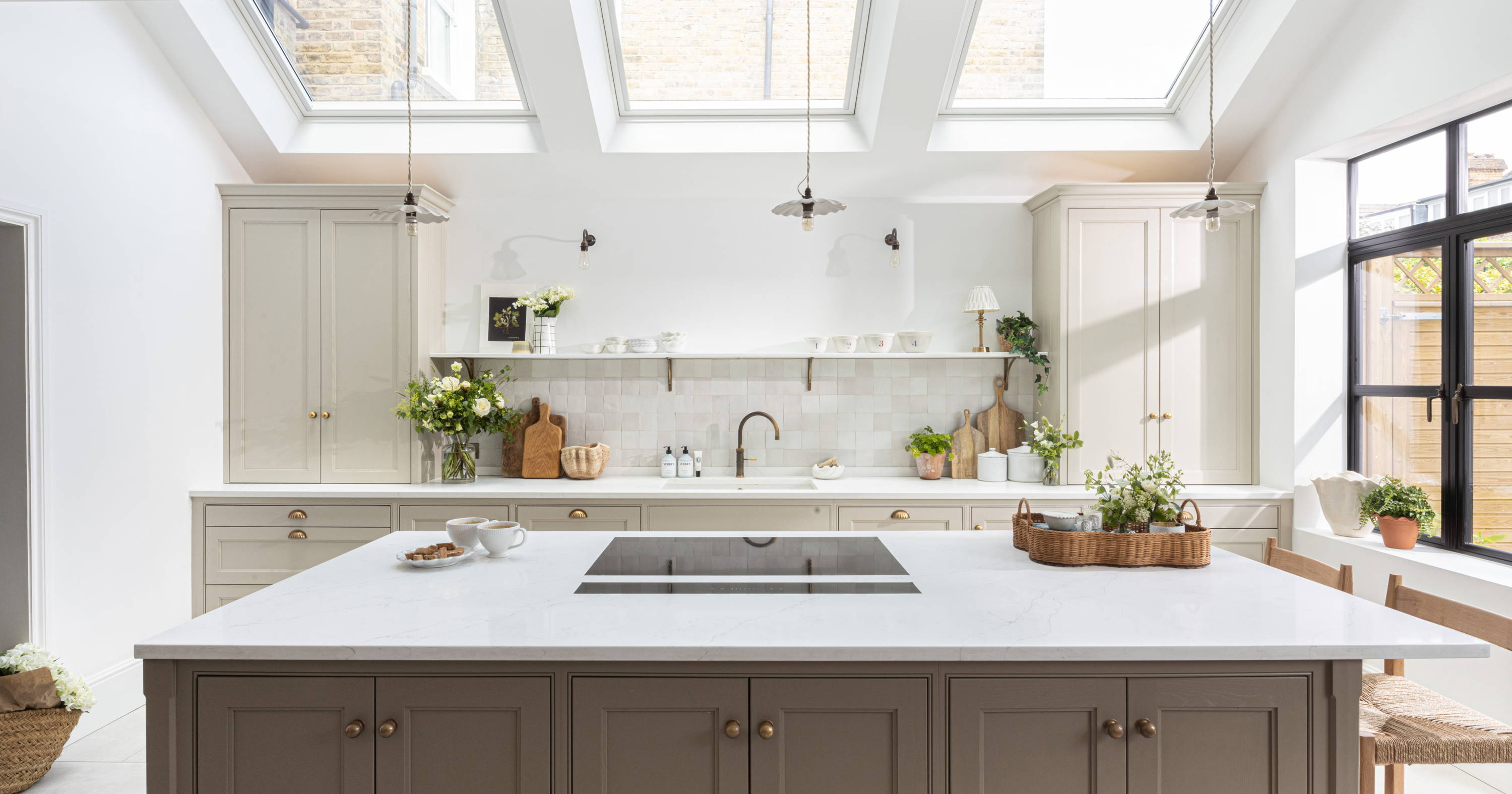 A calm, light-filled kitchen with warm neutral cabinetry